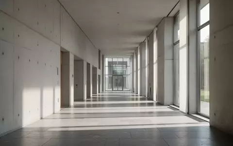 Ein leerer, modern gestalteter Flur in einem öffentlichen Gebäude mit minimalistischer Architektur und einfallendem Tageslicht. - Foto: über boerse-global.de