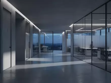 Ein minimalistisches, modern gestaltetes Büro bei Dämmerung mit architektonischen Linien und dezenter blauer Beleuchtung. - Foto: über boerse-global.de