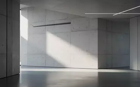 Ein minimalistischer, moderner Innenraum mit klaren, geometrischen Linien und natürlichem Licht auf einer Betonwand. - Foto: über boerse-global.de