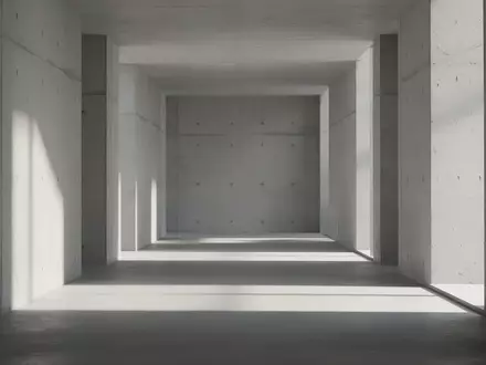 Ein minimalistischer, leerer Flur mit klaren Betonwänden und sanftem, natürlichem Licht, der eine ruhige architektonische Umgebung darstellt. - Foto: über boerse-global.de