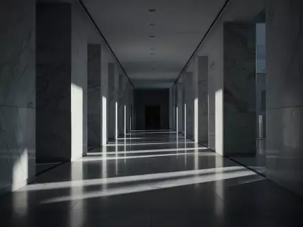 Ein minimalistischer, leerer Flur in einem modernen Gebäude mit langen, scharfen Schatten bei Dämmerlicht. - Foto: über boerse-global.de