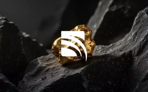 Ein rauer Goldklumpen auf dunklem, geologischem Gestein in einer professionellen, atmosphärischen Aufnahme. - Foto: über boerse-global.de
