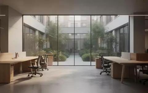 Ein minimalistisches, modernes Großraumbüro mit hellen Holztischen und großen Fensterfronten in einer ruhigen Arbeitsumgebung. - Foto: über boerse-global.de