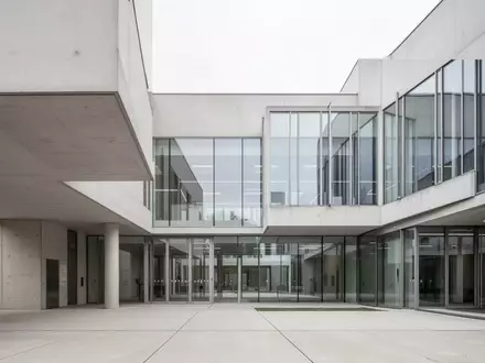 Modernes Verwaltungsgebäude mit schlichter Architektur und Glasfassade bei Tageslicht. - Foto: über boerse-global.de