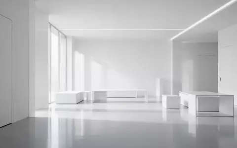 Ein minimalistisch gestalteter, heller Raum mit weiĂen OberflĂ€chen und klaren architektonischen Linien ohne sichtbare GerĂ€te. - Foto: ĂŒber boerse-global.de