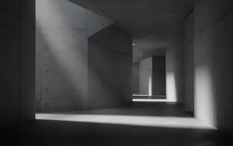 Ein minimalistischer, modern gestalteter Flur mit Betonwänden und diffusem Licht, der eine ruhige und nachdenkliche Stimmung erzeugt. - Foto: über boerse-global.de