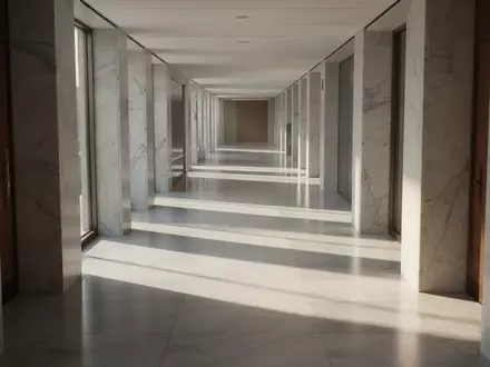 Ein minimalistischer, heller Flur in einem modernen Bürogebäude mit architektonischen Linien und Schattenwurf. - Foto: über boerse-global.de