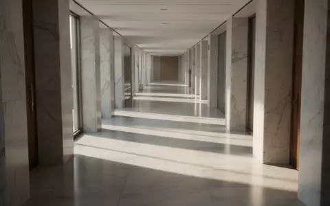 Ein minimalistischer, heller Flur in einem modernen Bürogebäude mit architektonischen Linien und Schattenwurf. - Foto: über boerse-global.de