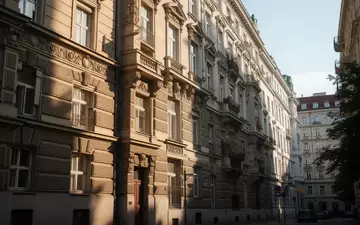 Fassade eines Wiener Gemeindebaus bei sommerlichem Sonnenlicht mit Blick auf die architektonische Struktur. - Foto: über boerse-global.de