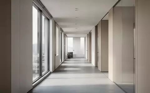 Ein minimalistischer, moderner Büroflur mit natürlichem Lichteinfall und klarer Architektur. - Foto: über boerse-global.de