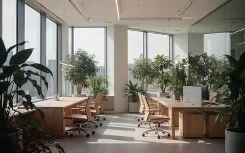 Ein helles, minimalistisches Büro mit großen Fenstern und Zimmerpflanzen, das eine gesunde Arbeitsumgebung symbolisiert. - Foto: über boerse-global.de