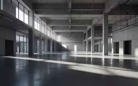 Minimalistische, moderne Architektur mit klaren geometrischen Schatten auf einem Betonboden in einer großen Halle. - Foto: über boerse-global.de
