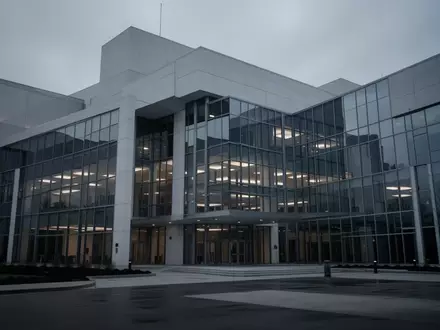 Ein modernes, steriles Regierungsgebäude in der Dämmerung, das eine Atmosphäre institutioneller Kontrolle und behördlicher Aufsicht vermittelt. - Foto: über boerse-global.de