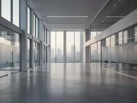 Ein minimalistischer, moderner Innenraum mit polierten Betonböden und Glaswänden in einem Bürogebäude. - Foto: über boerse-global.de