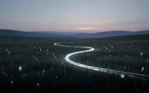 Ruhige, abstrakte Landschaft mit leuchtendem Glasfaserkabel im Gras, das nahtlose digitale Konnektivität symbolisiert. - Foto: über boerse-global.de