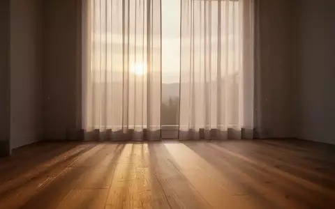 Ein ruhiger, minimalistischer Raum bei Tagesanbruch mit sanftem Licht und Schatten auf einem Holzboden. - Foto: über boerse-global.de