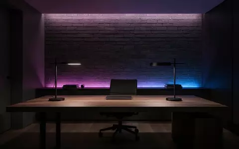 Ein modern gestalteter, minimalistischer Arbeitsplatz mit dunklem Holzschreibtisch und dezenter, stimmungsvoller Beleuchtung. - Foto: über boerse-global.de