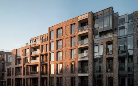 Fassade eines modernen Wohnblocks in einer deutschen Stadt im warmen Licht der Abendsonne. - Foto: über boerse-global.de
