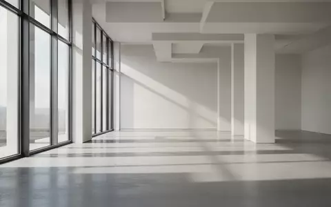 Ein minimalistischer, lichtdurchfluteter Raum mit klaren architektonischen Linien und geometrischen Schattenwürfen. - Foto: über boerse-global.de