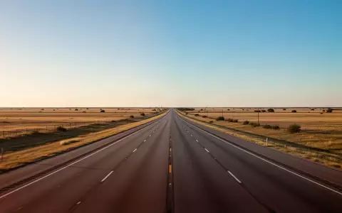 Eine leere, weite Autobahn in der texanischen Landschaft bei Sonnenuntergang, die einen Logistikkorridor symbolisiert. - Foto: über boerse-global.de