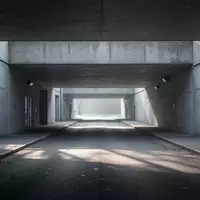 Ein leerer, grauer Beton-Unterführungsgang mit minimalistischer Architektur bei kühlem Tageslicht. - Foto: über boerse-global.de