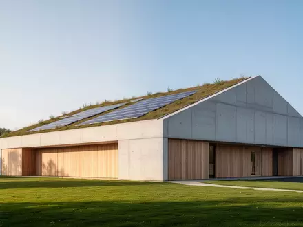 Ein moderner, nachhaltiger Sporthallenbau mit begrüntem Dach und Solaranlagen in einer weitläufigen Außenanlage. - Foto: über boerse-global.de