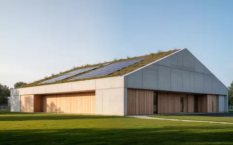 Ein moderner, nachhaltiger Sporthallenbau mit begrüntem Dach und Solaranlagen in einer weitläufigen Außenanlage. - Foto: über boerse-global.de