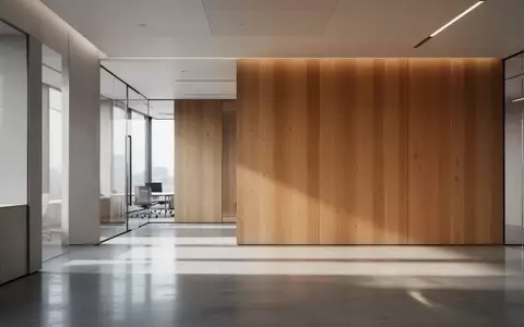 Ein minimalistischer, moderner Innenraum mit klaren Linien und sanftem, natürlichem Licht, das auf eine Holzwand trifft. - Foto: über boerse-global.de