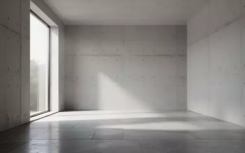 Minimalistischer, moderner Innenraum mit Betonwänden und weichem Tageslichteinfall, keine Personen oder Technik sichtbar. - Foto: über boerse-global.de