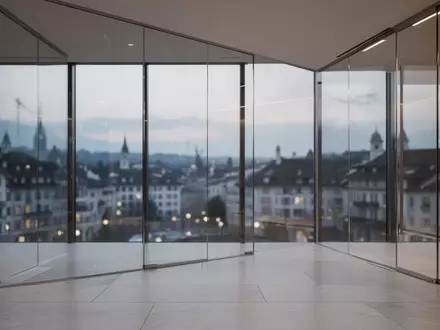 Modernes, minimalistisches Bürogebäude in Zürich mit großen Glasfronten bei Dämmerung. - Foto: über boerse-global.de