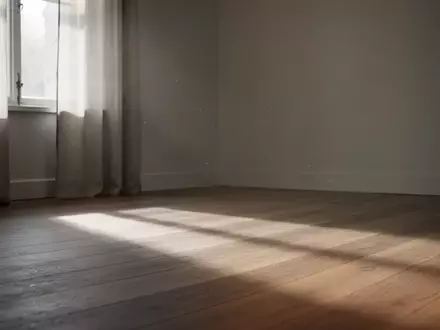 Ein ruhiger, minimalistischer Raum mit sanftem Tageslicht, das durch ein Fenster fällt und Schatten auf einen Holzboden wirft. - Foto: über boerse-global.de