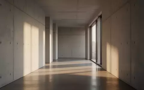 Ein leerer, modern gestalteter Büroflur mit Betonwänden und einfallendem Tageslicht. - Foto: über boerse-global.de