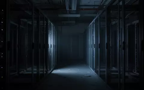 Ein dunkler, leerer Serverraum mit metallischen Regalen in kühlem, blauem Licht. - Foto: über boerse-global.de