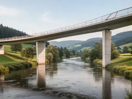 Eine moderne Betonbrücke über einen Fluss in einer grünen Landschaft in Baden-Württemberg. - Foto: über boerse-global.de