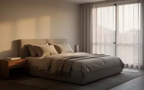 Ein minimalistisch eingerichtetes Schlafzimmer bei Morgenlicht mit einem ordentlich gemachten Bett und einem Holznachttisch. - Foto: über boerse-global.de