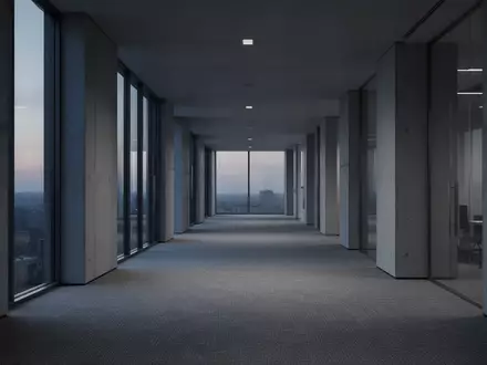Ein leerer, minimalistischer Büroflur in kühlem Dämmerlicht, der Stille und architektonische Weite vermittelt. - Foto: über boerse-global.de