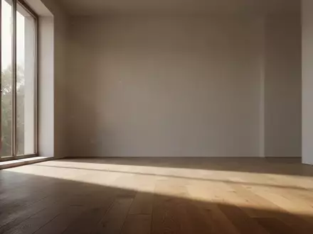 Ein minimalistischer, leerer Raum mit einfallendem Tageslicht und langen Schatten auf einem Holzboden. - Foto: über boerse-global.de