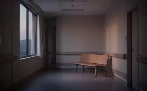 Ein minimalistischer, leerer Krankenhausflur in gedämpftem Licht, der eine ruhige und nachdenkliche Atmosphäre vermittelt. - Foto: über boerse-global.de