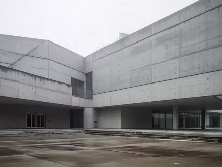 Modernes Verwaltungsgebäude mit minimalistischer Architektur bei bewölktem Himmel. - Foto: über boerse-global.de
