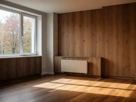 Ein minimalistisch gestalteter Wohnraum mit einem Heizkörper unter einem Fenster bei natürlichem Lichteinfall. - Foto: über boerse-global.de