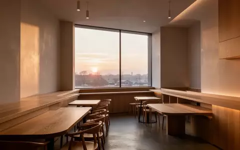 Ein minimalistischer, heller Innenraum eines Cafés mit sauberen Linien und natürlichem Lichteinfall ohne Personen oder Technik. - Foto: über boerse-global.de