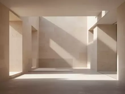 Eine minimalistische, moderne Architektur auf Mallorca mit klaren Linien, Steinwänden und weichem, natürlichem Licht. - Foto: über boerse-global.de