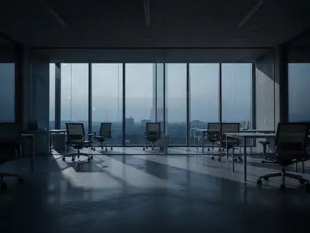 Ein leeres, minimalistisches Büro in der Dämmerung mit langen Schatten und kühlem Licht. - Foto: über boerse-global.de