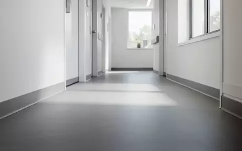 Ein minimalistischer Flur in einer modernen Pflegeeinrichtung mit neutralen Bodenbelägen und klaren architektonischen Linien. - Foto: über boerse-global.de