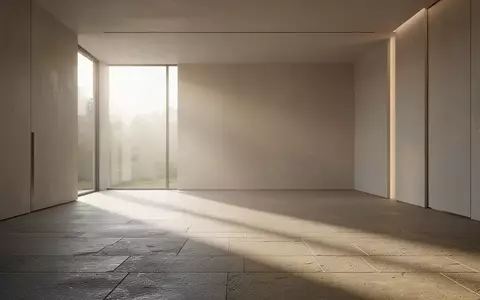 Minimalistischer, lichtdurchfluteter Innenraum mit klaren Linien und sanften Schatten auf einem Steinfußboden. - Foto: über boerse-global.de