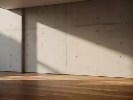 Ein minimalistischer, moderner Innenraum mit klaren architektonischen Linien und weichem, natürlichem Tageslicht. - Foto: über boerse-global.de