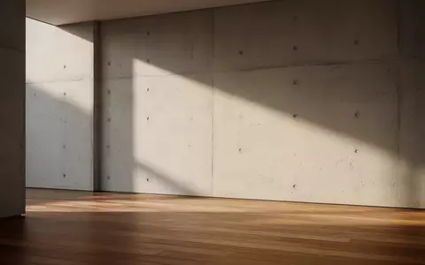 Ein minimalistischer, moderner Innenraum mit klaren architektonischen Linien und weichem, natürlichem Tageslicht. - Foto: über boerse-global.de