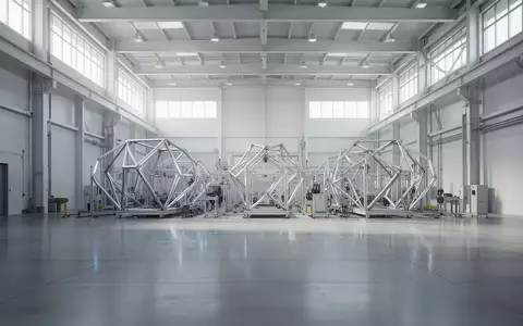 Eine leere, moderne Industriehalle mit hellen Betonböden und diffuser Beleuchtung, die eine technologische Umgebung andeutet. - Foto: über boerse-global.de