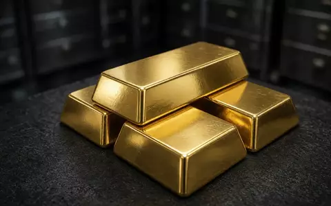 Gestapelte Goldbarren auf einer dunklen Oberfläche in einem Tresor. - Foto: über boerse-global.de