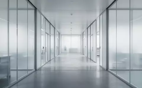 Ein minimalistischer, moderner Flur in einem Forschungsgebäude mit klaren architektonischen Linien und diffusem Licht. - Foto: über boerse-global.de